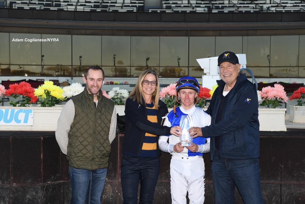 Jaime Roth holds the trophy with Jockey Dylan Davis. (Adam Coglianese/NYRA)