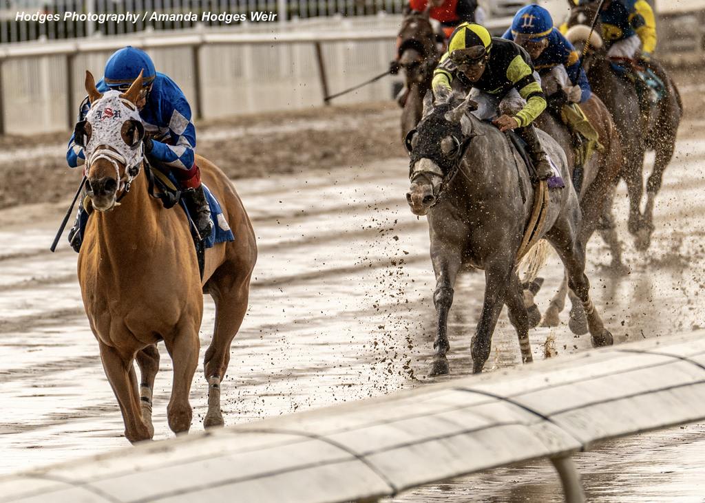 Kavod with jockey Frankie Dettori aboard pulls away over a muddy track to ​win the 72nd running of the Duncan F. Kenner Stakes. (Hodges Photography / Amanda Hodges Weir)