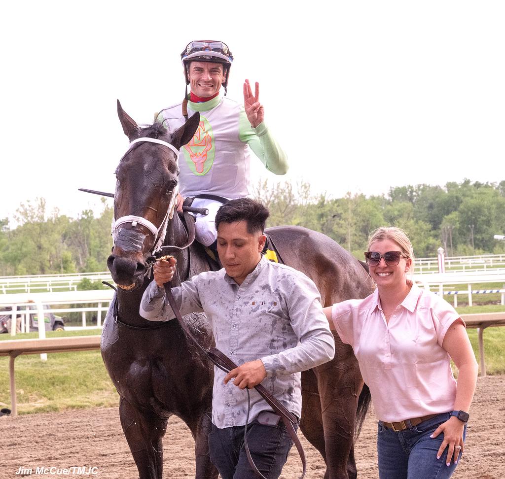 Russell (right) and husband and jockey Sheldon Russell (left) head to the winner’s circle on a three-win day at Laurel Park. (Jim McCue/TMJC)
