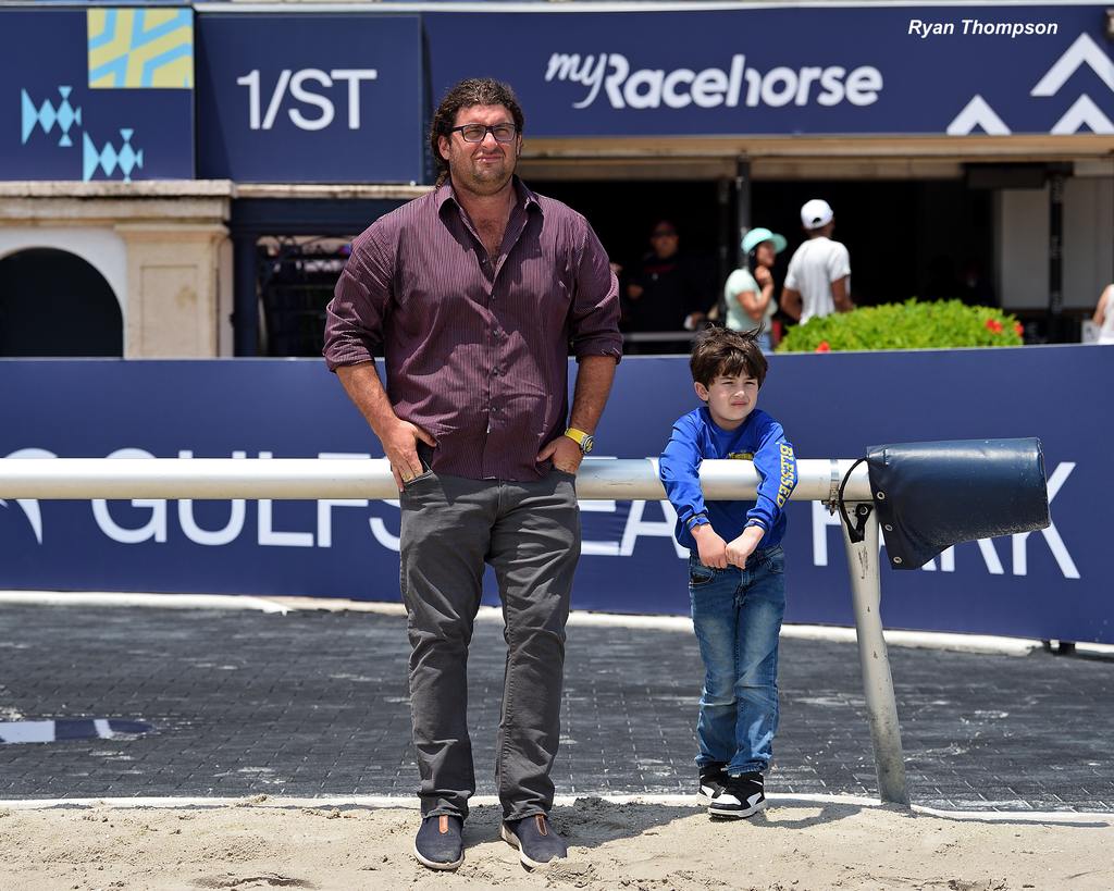 Trainer Saffie Joseph, Jr., with his son watching a work at Gulfstream Park. (Ryan Thompson)