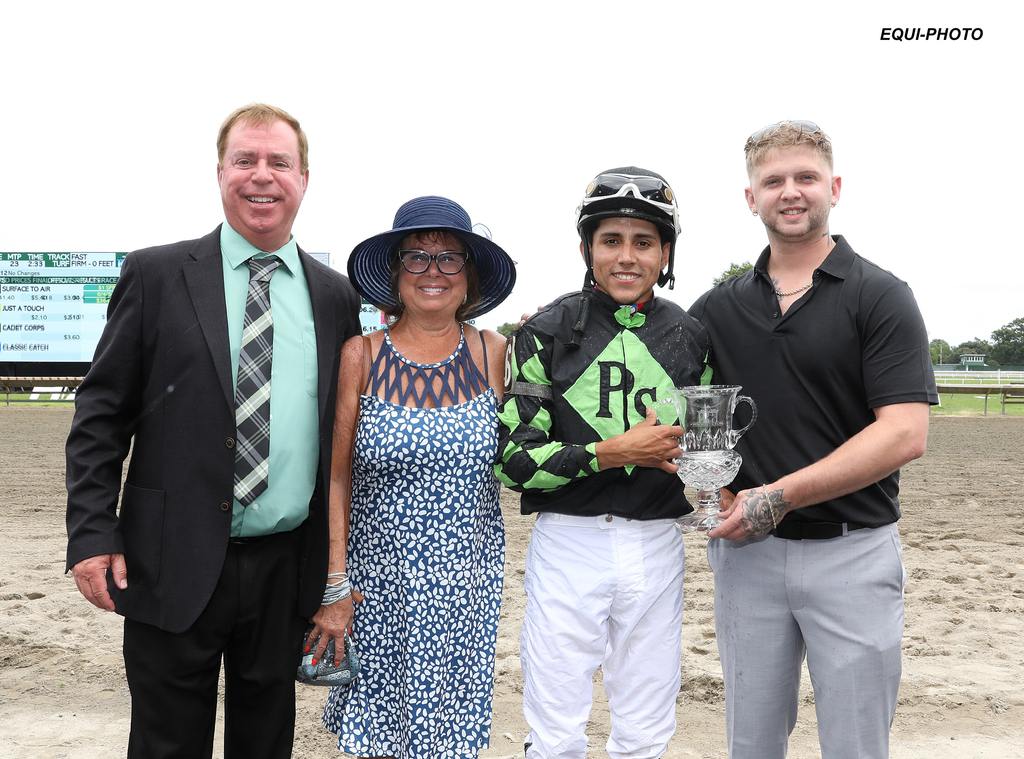Peter Synnefias (right) holds the trophy with (l to r) Premier Stables Brian and Lori Shyda, Jockey Samuel Marin. (Bill Denver/EQUI-PHOTO)