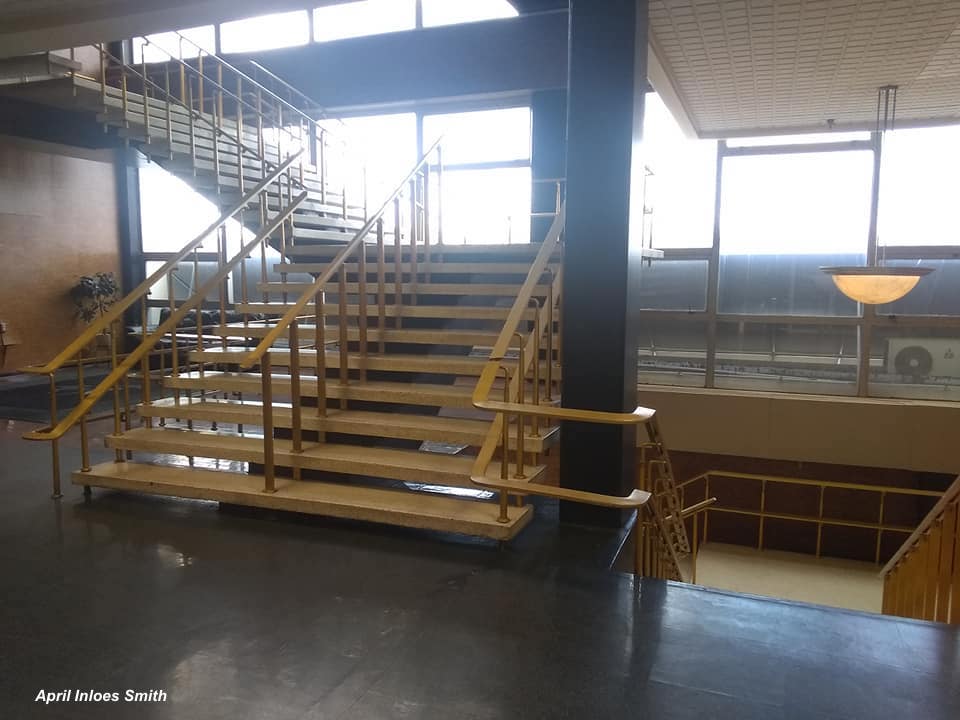 The free-standing staircase in Pimlico's clubhouse are a Mid-century technological marvel. The aluminum banister was gilt soon after construction. (April Inloes Smith)