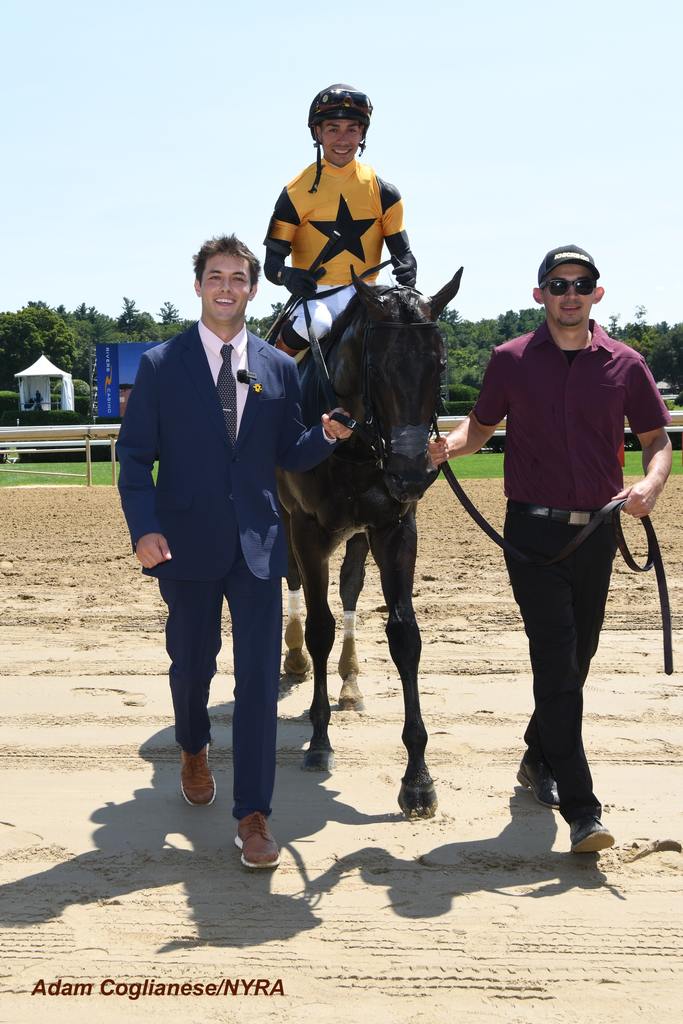 Ewing, part owner Griffin Johnson and Ewing’s groom all head to the winner’s circle. (Adam Coglianese/NYRA)