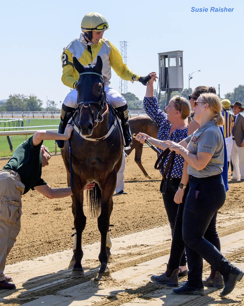 Trainer Keri Brion congratulates jockey Mulqueen on the victory. (Susie Raisher)