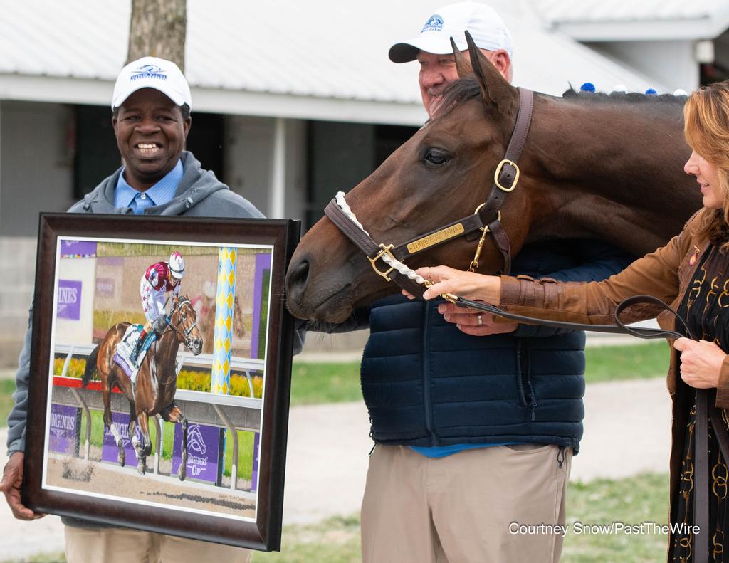 Groom Cordell Anderson holds the Clark portrait of Thorpedo Anna with Kenny McPeek and of course, Thorpedo Anna. (Courtney Snow/Past The Wire)