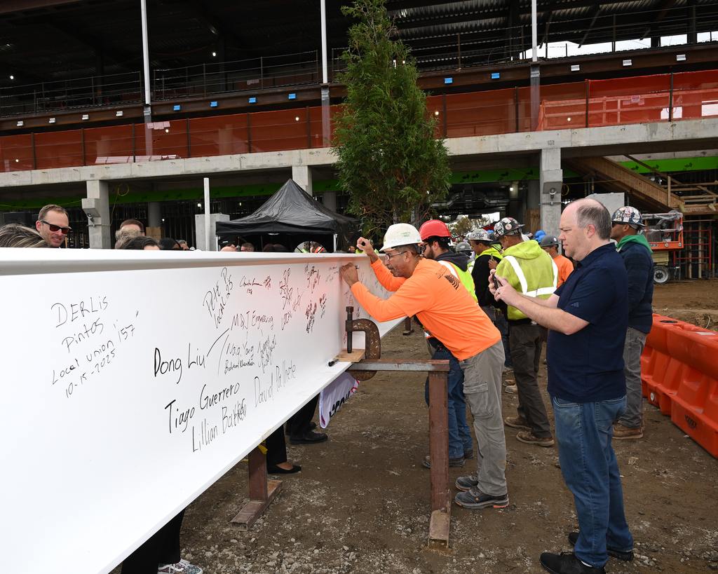 Traditionally held to mark the completion of a building’s highest structural element, today’s ceremony involved the raising and placement of a steel beam adorned with the American flag and an evergreen tree to convey good luck. (NYRA Photo)